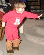 Liralyn walking in Daddy's boots.