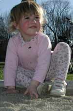 Liralyn playing in a sandbox.